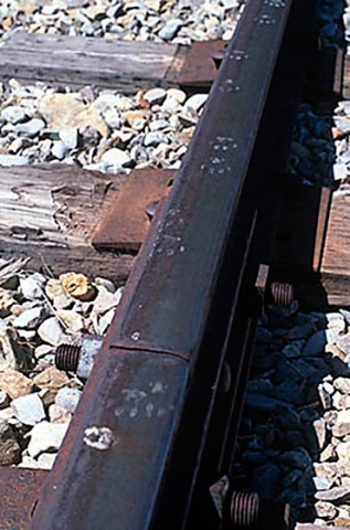 "Tracks" Footprints on top of a steel rail.