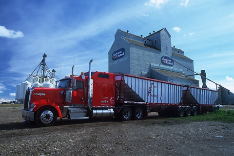 Grain truck with wooden grain elevator at Grande Prairie, Alberta
