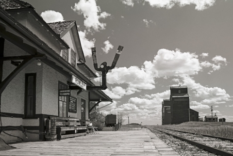 "Too Late" Station and wooden grain elevators at Rowley, Alberta, 