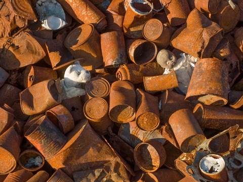 Toys amongst rusting tin cans